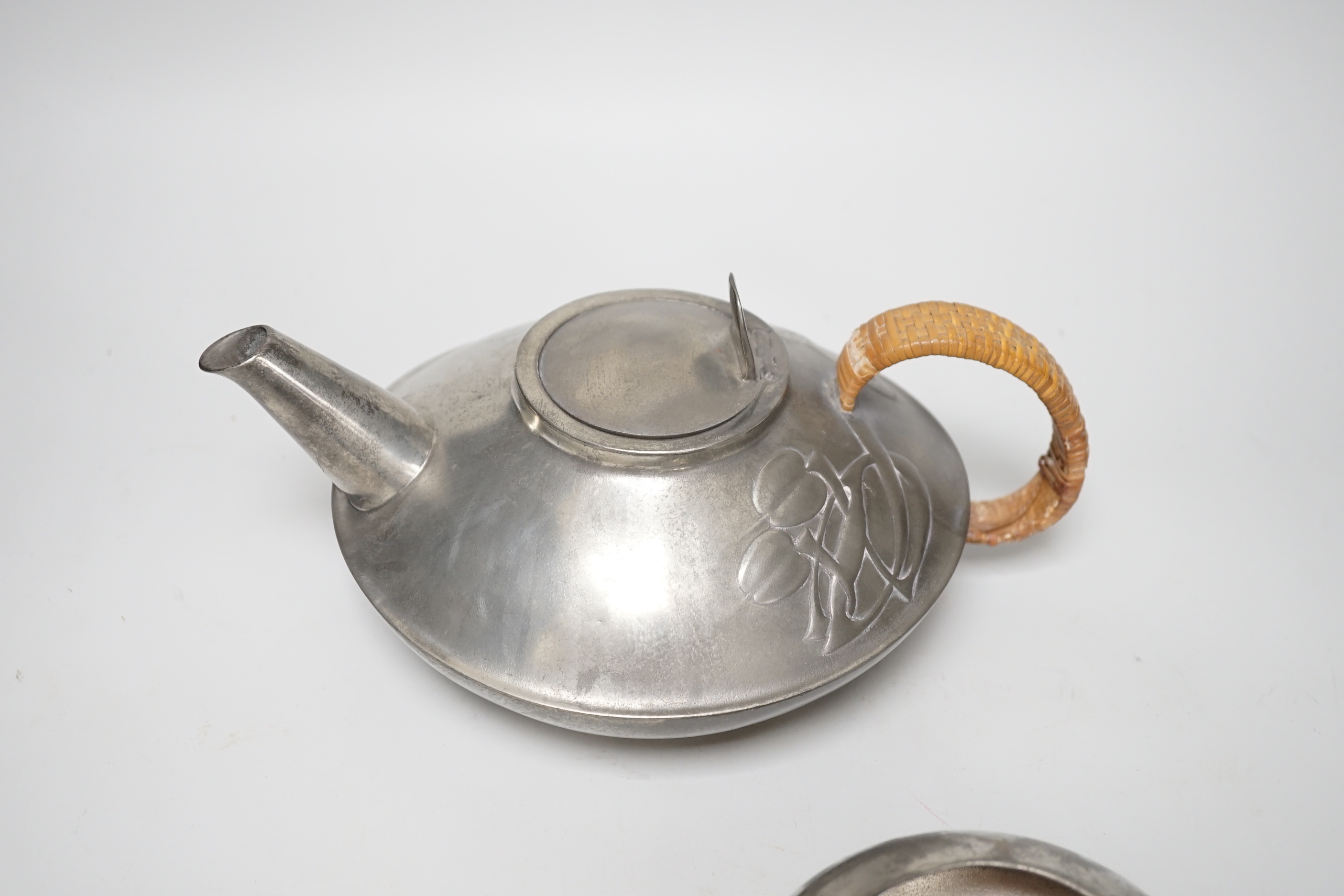 Art Nouveau Archibald Knox for Liberty, Tudric pewter three piece tea set, the teapot with woven handle, each stamped 0231 to the base, the largest 23cm wide